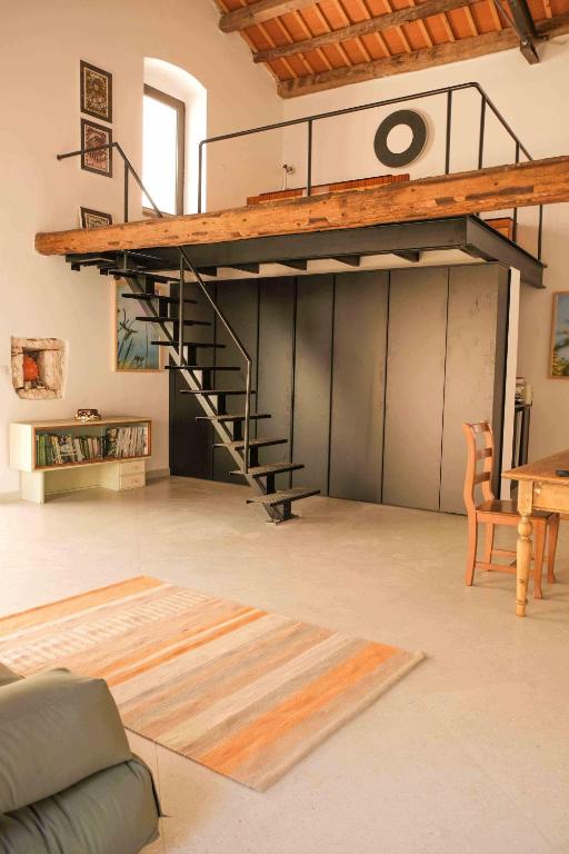 a living room with a loft bed and a table at Apartman Mak in Vodnjan