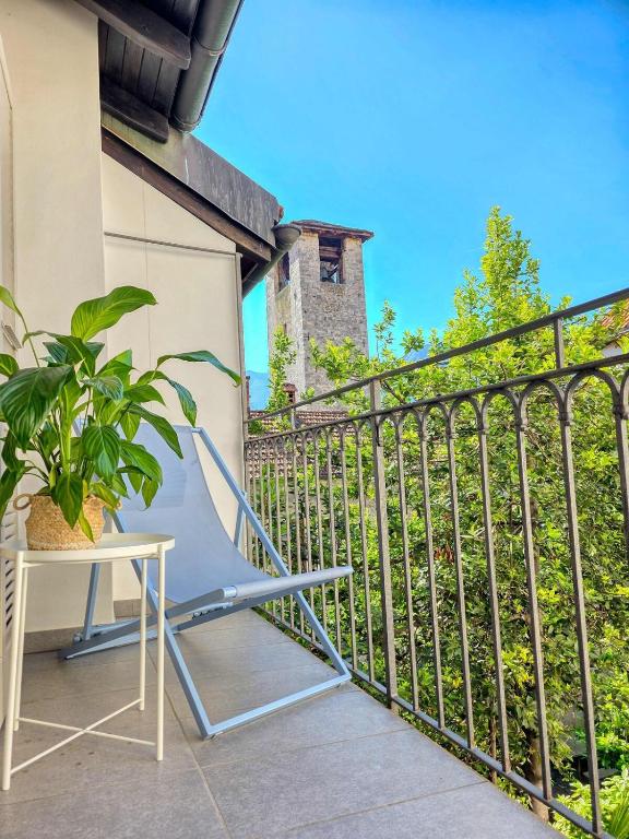 a chair on a balcony with a plant at Alla Torre - Città Vecchia Locarno in Locarno
