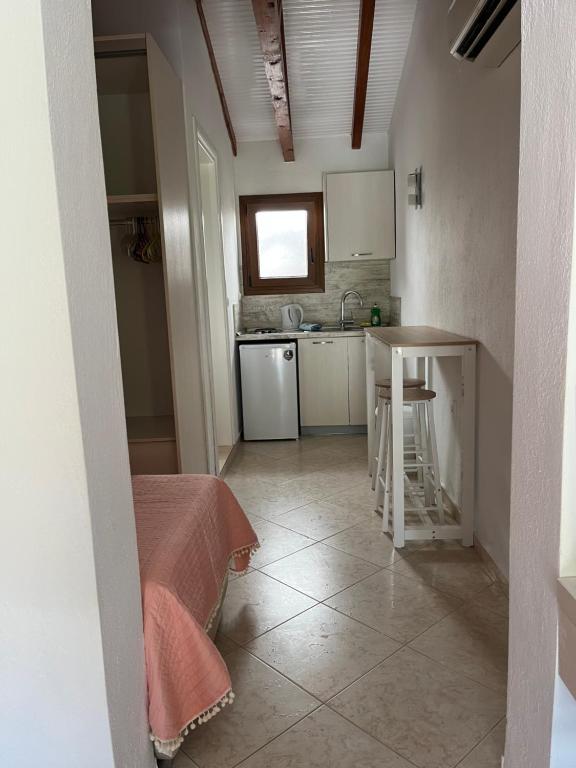 a small kitchen with a table and a sink at Maniatis Garden in Achladies
