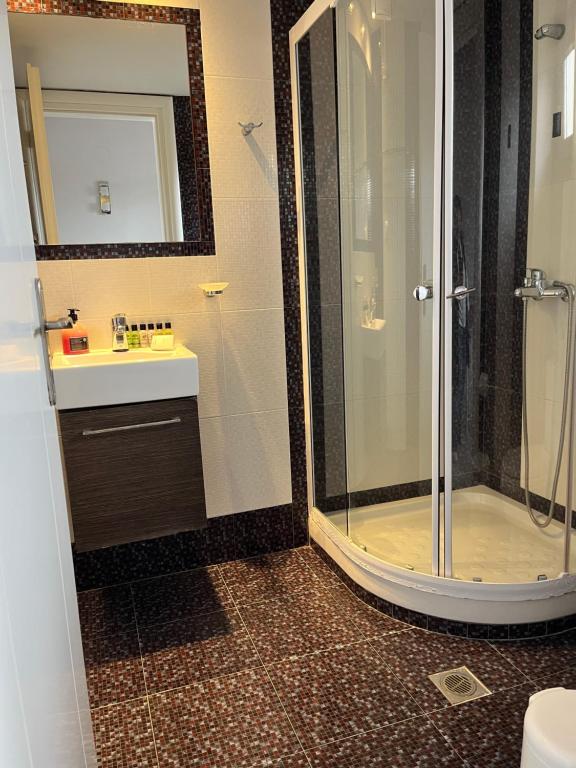 a bathroom with a shower and a sink at Maniatis Garden in Achladies
