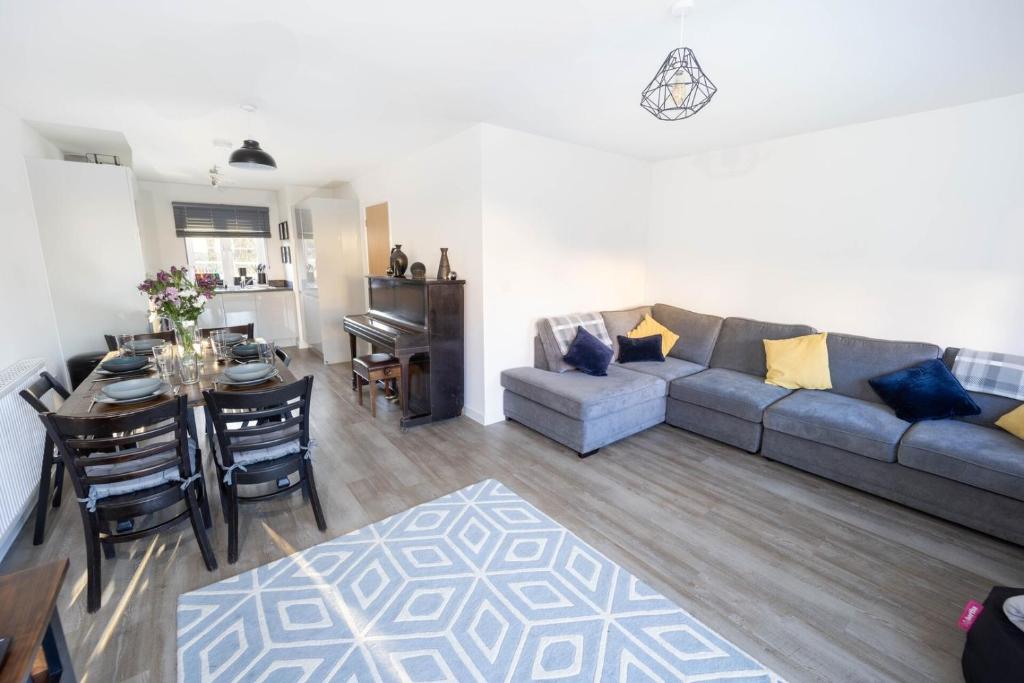 a living room with a couch and a table at Immaculate 3 Bedroom Home Barnstaple Devon in Barnstaple