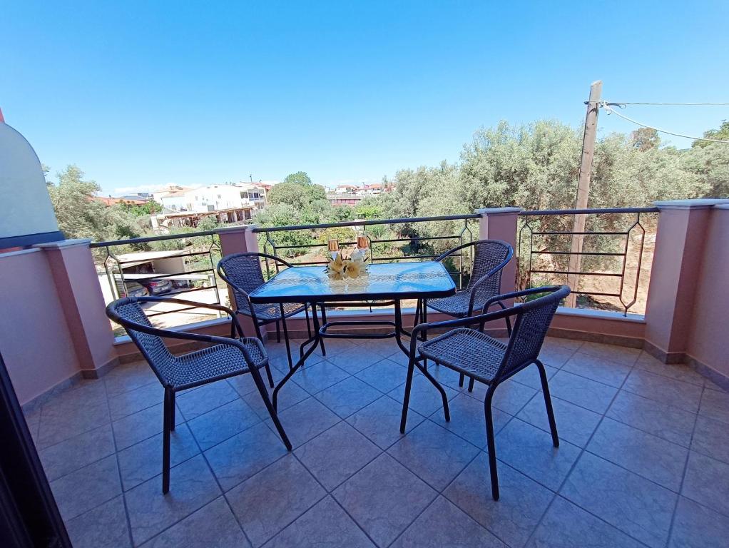 a table and four chairs on a balcony at Georgias House in Lefkada