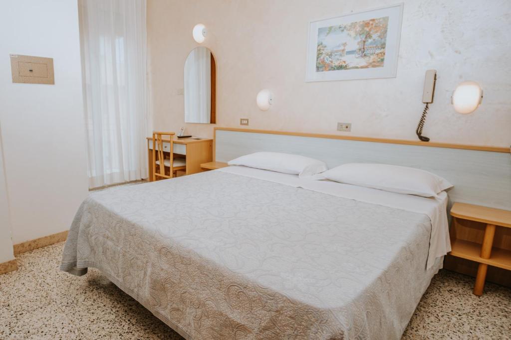 Postel nebo postele na pokoji v ubytování Hotel Gabriella