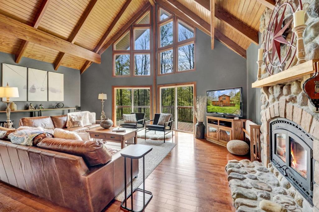 a large living room with a large stone fireplace at Secluded 3BR Home Fire Pit Covered Deck in Salamanca