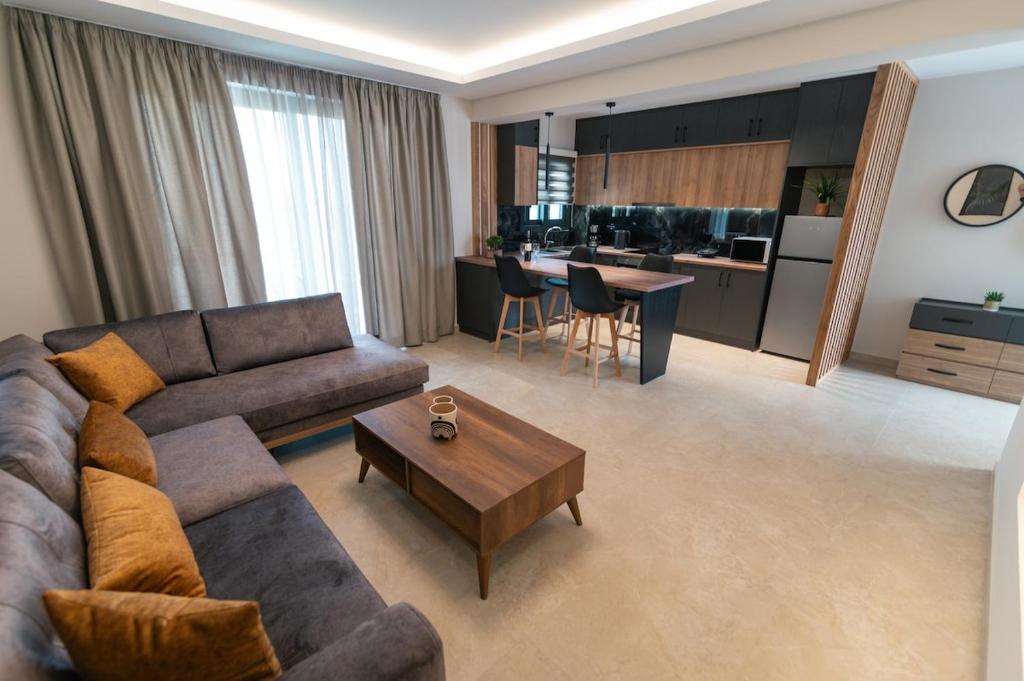 a living room with a couch and a table at Aurora Apart, 4 - Sea view suites near the beach in Marmari