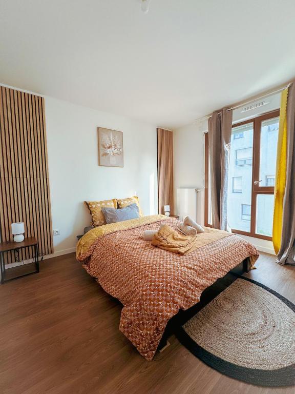 une chambre avec un lit et une grande fenêtre dans l'établissement Elegancia Stade de France, proche Paris, à Pierrefitte-sur-Seine