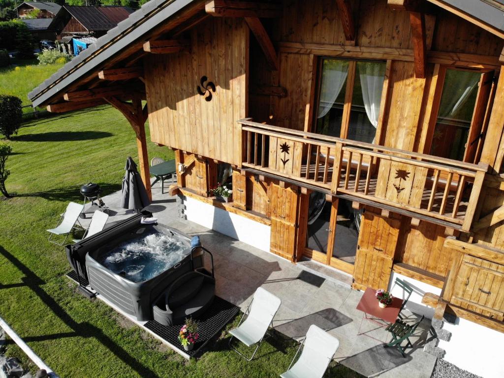 an overhead view of a house with a hot tub on a patio at Chalet Pétérets in Samoëns
