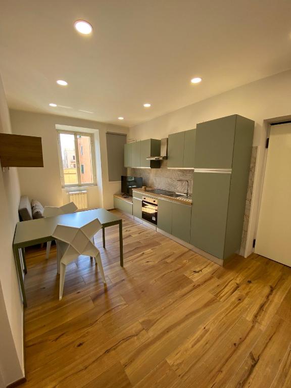 a kitchen with a table and a dining room at Begonia Apartment in Rome