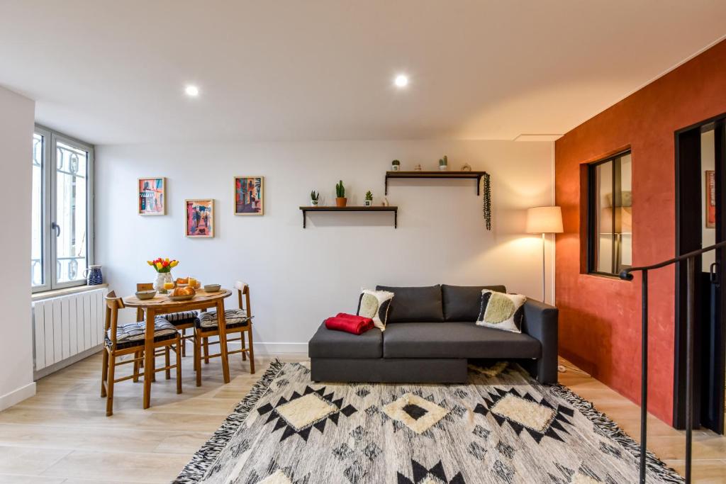 un salon avec un canapé et une table dans l'établissement Le Jardin de Frida by CozyLife - Cœur de Ville, à Niort