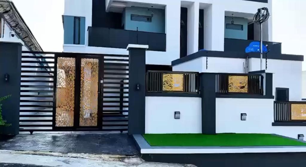a house with a front door and stairs at Sohana Homes in Ikeja