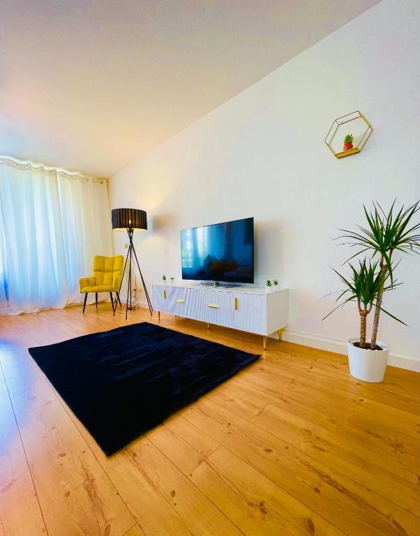 a living room with a flat screen tv on a wall at Schwarzwald-Idylle in Schonach in Schonach
