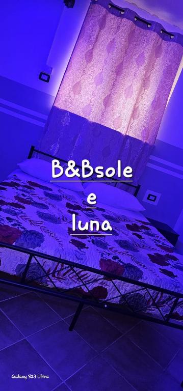 a bed with the words bebia a liao on it at B&B SOLE e LUNA in Pontecagnano