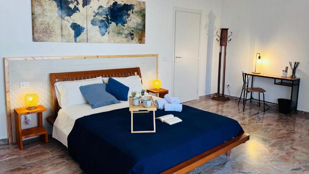 a bedroom with a large bed with blue sheets and blue pillows at Stella dei Venti B&B in San Salvo