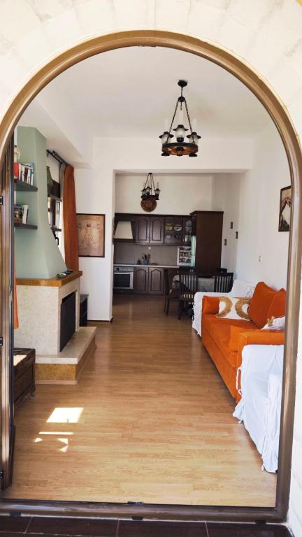 a living room with an archway leading to a bedroom at Anemi in Kamilari