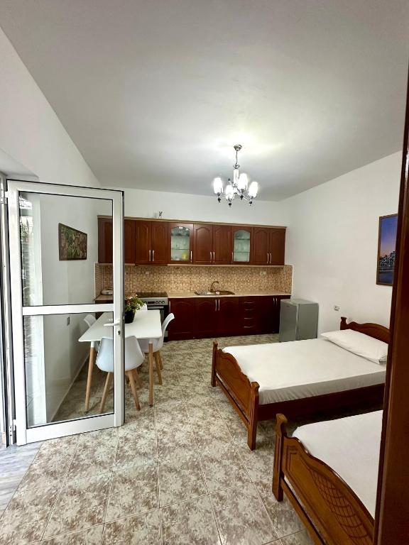 a bedroom with a bed and a sink and a mirror at Chris apartament 2 in Polisi i Vogël