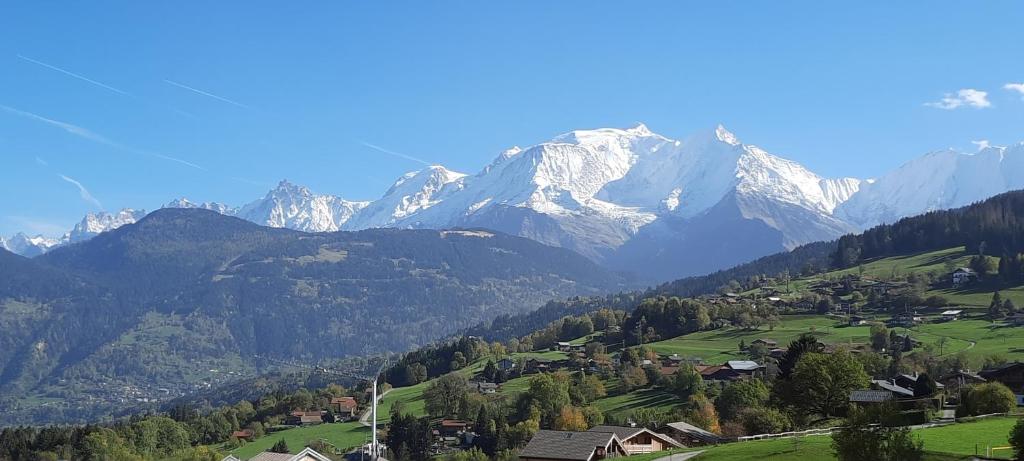 un village dans une vallée avec des montagnes en arrière-plan dans l'établissement Cocon cozy, vue magique, à Demi-Quartier