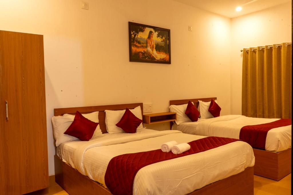 Postel nebo postele na pokoji v ubytování De Asian Resort Pondicherry