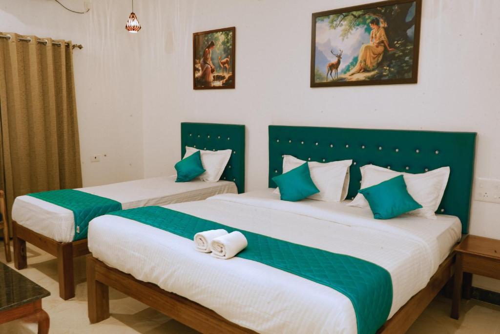 Postel nebo postele na pokoji v ubytování De Asian Resort Pondicherry