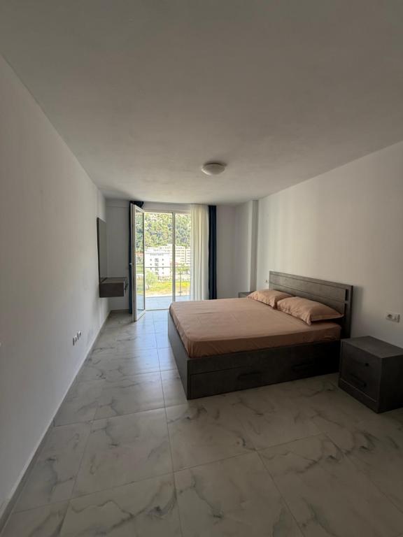 a bedroom with a bed and a television in it at 9apartaments Shengjin in Shëngjin