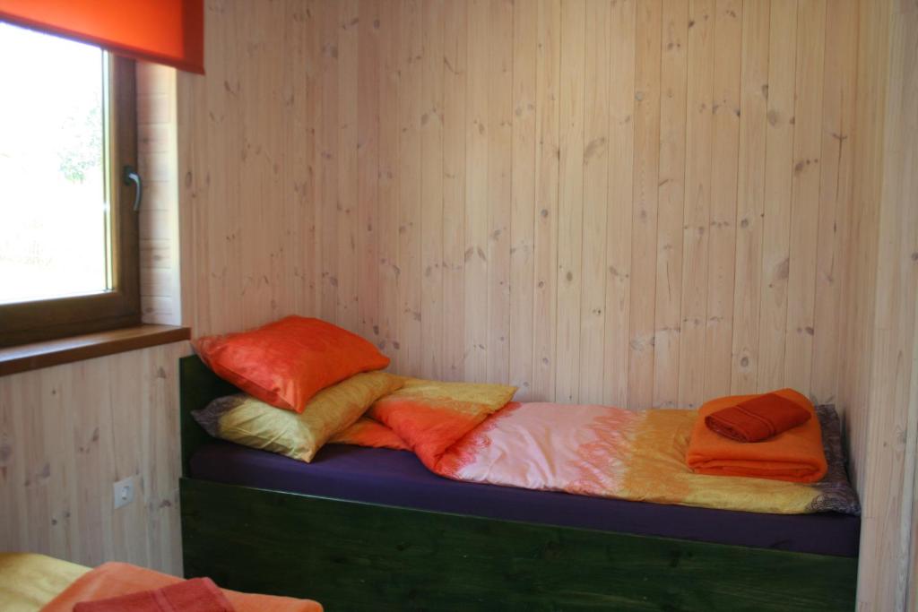 two piles of pillows on a bed in a room at Grāveri kempings in Usma