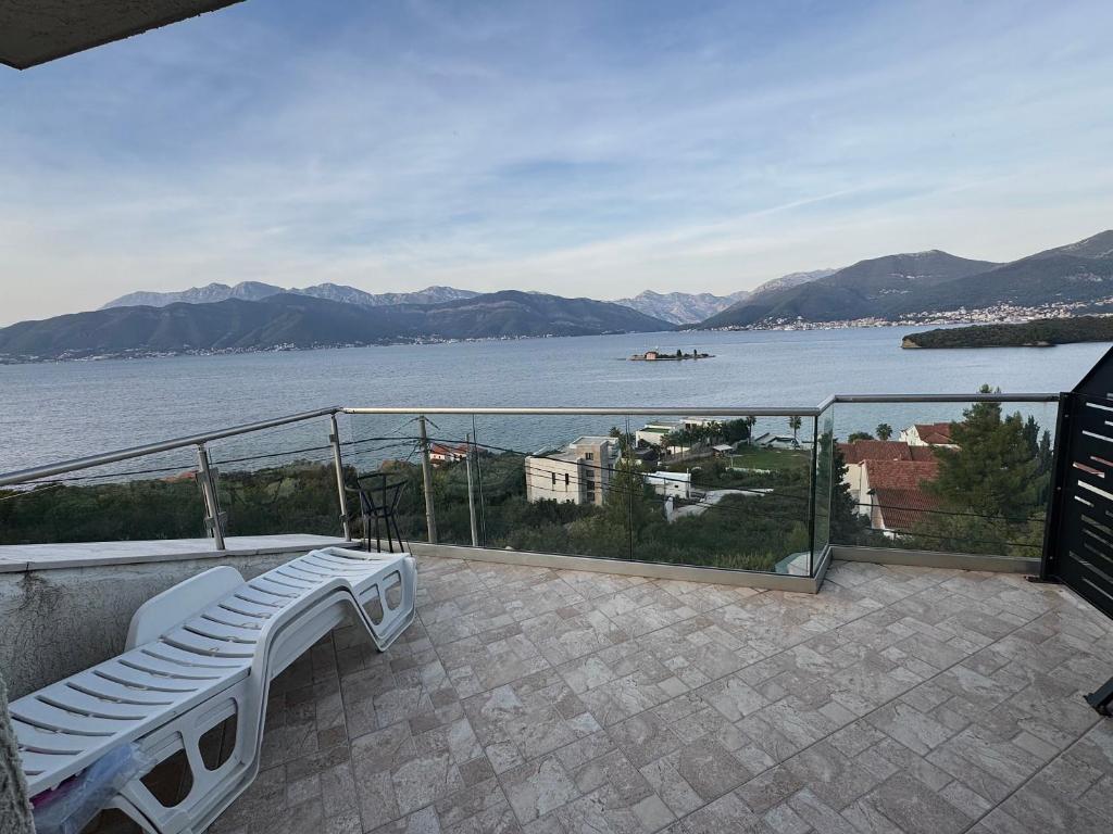a balcony with a view of a body of water at Sunset Heaven Kaluđerovina in Tivat