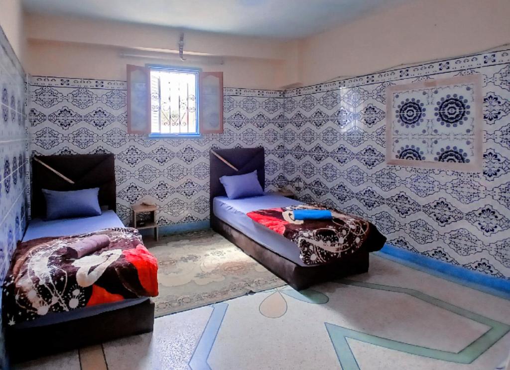 Postel nebo postele na pokoji v ubytování Tayrt Hostel
