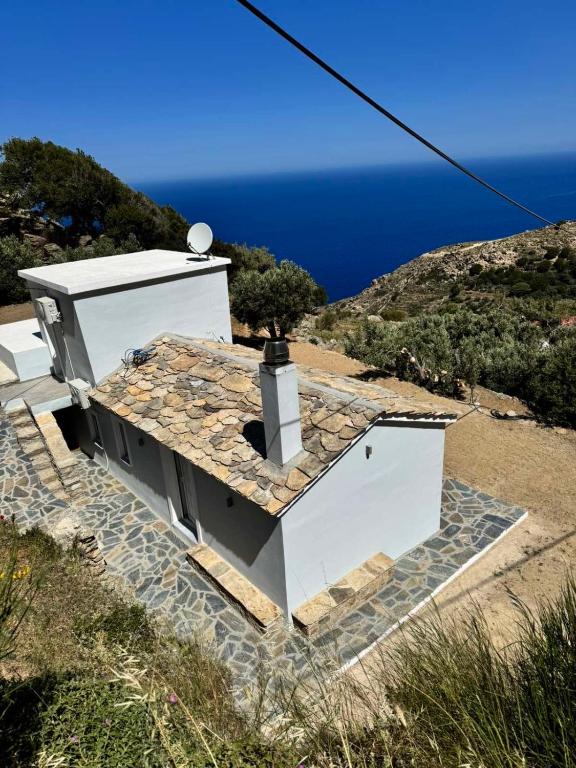 a small white building with a tree on the roof at Amalour Villa in Amálon