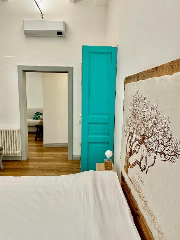 a bedroom with a blue door and a bed at Suites Cavallotti - Il Mandorlo in Orvieto