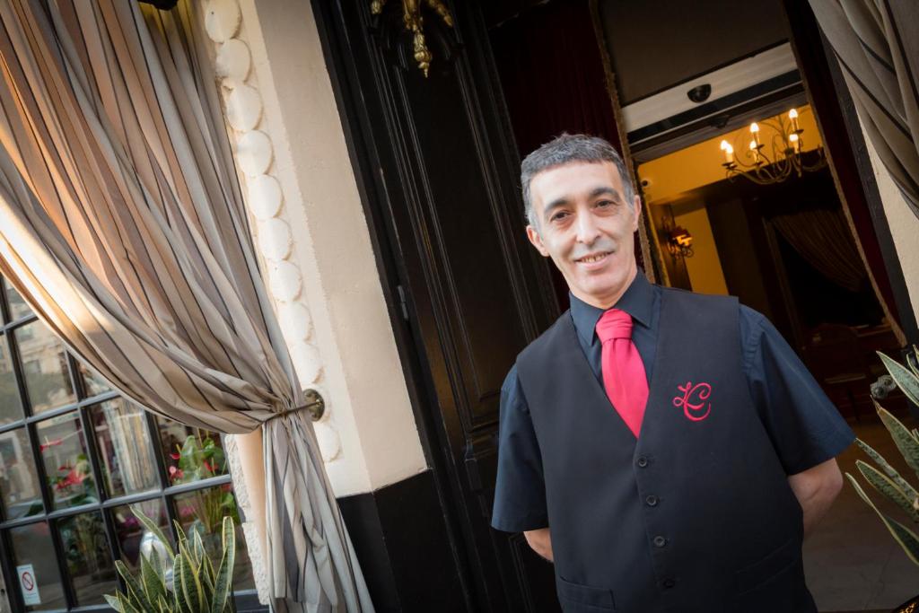 a man wearing a suit and a red tie at Le Cavendish in Cannes