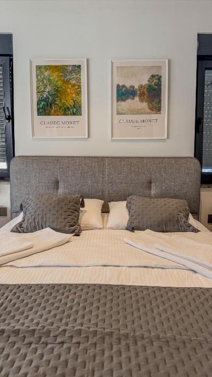 a bedroom with a large bed with two pictures on the wall at Leos Apartments Apart3 in Side
