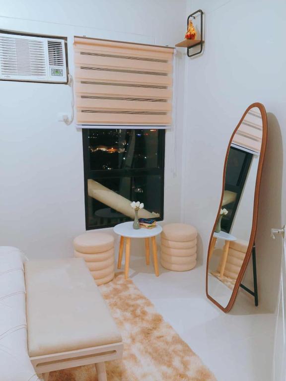a living room with a mirror and a white couch at Langga Crib in Lapu Lapu City