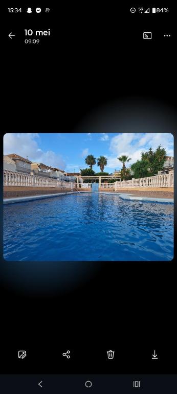 a television screen with a picture of a pool of water at Tranquilo Townhouse Casa Spain Kwintos in Torrevieja