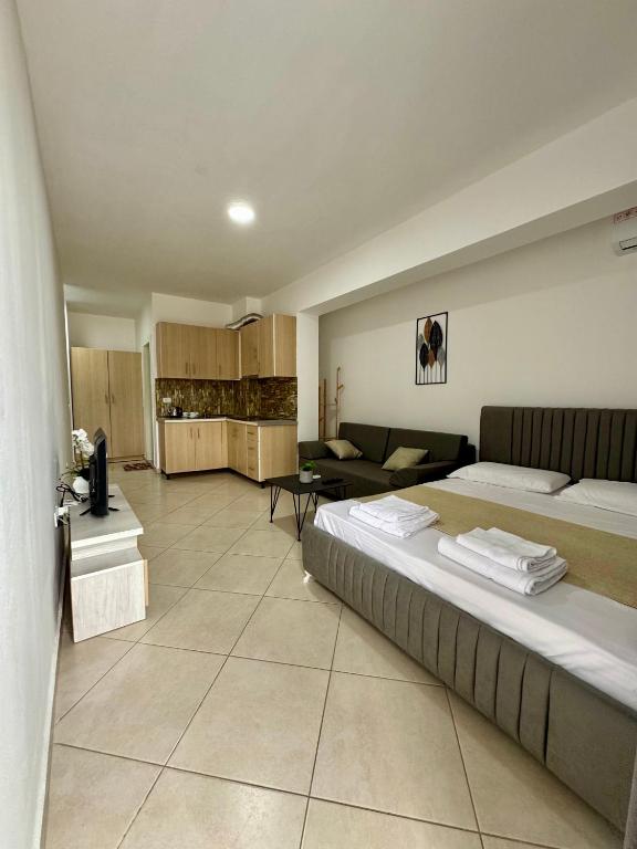 a bedroom with two beds and a living room at Apartament Niko Shengjin 1 in Shëngjin