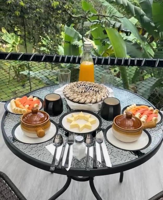 a table topped with plates of food on a table at Luxe Glamping in Moniquirá
