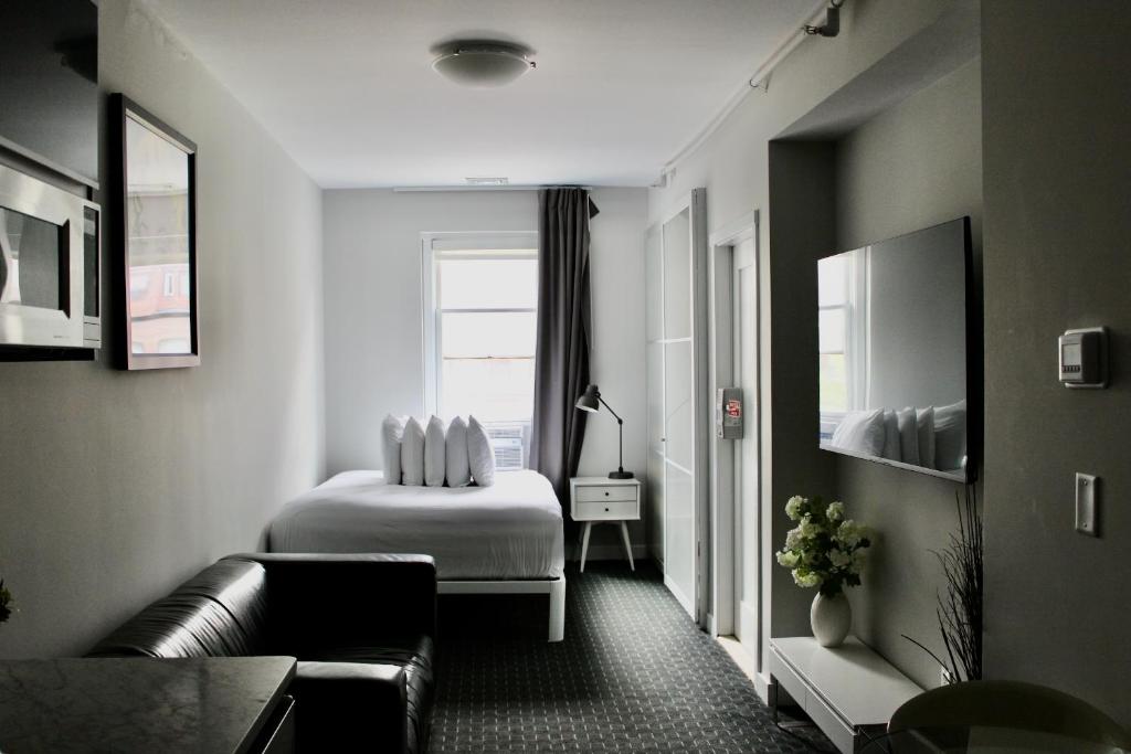 a living room with a bed and a couch at Comfortable Studio in Back Bay, Newbury St. #7 in Boston