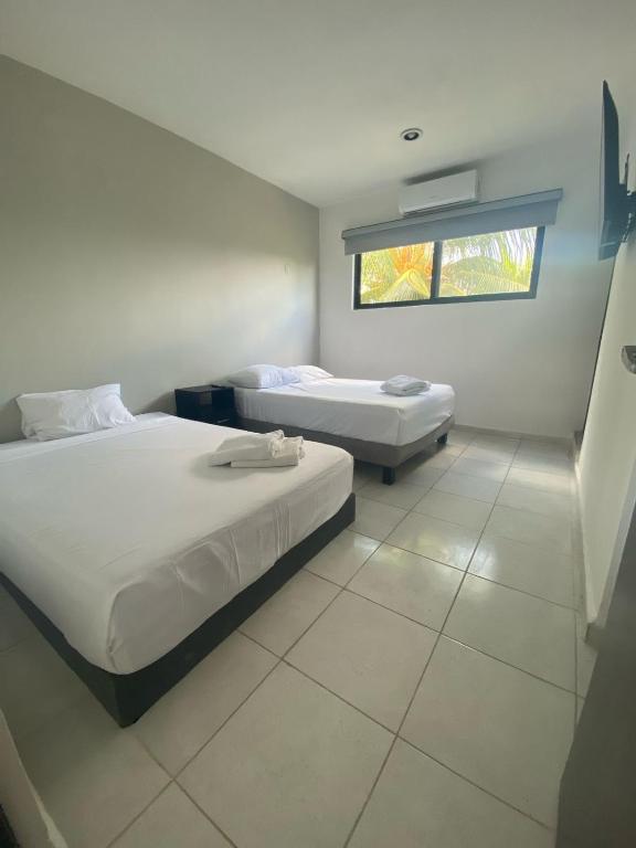 Postel nebo postele na pokoji v ubytování Hotel Suites La Maya