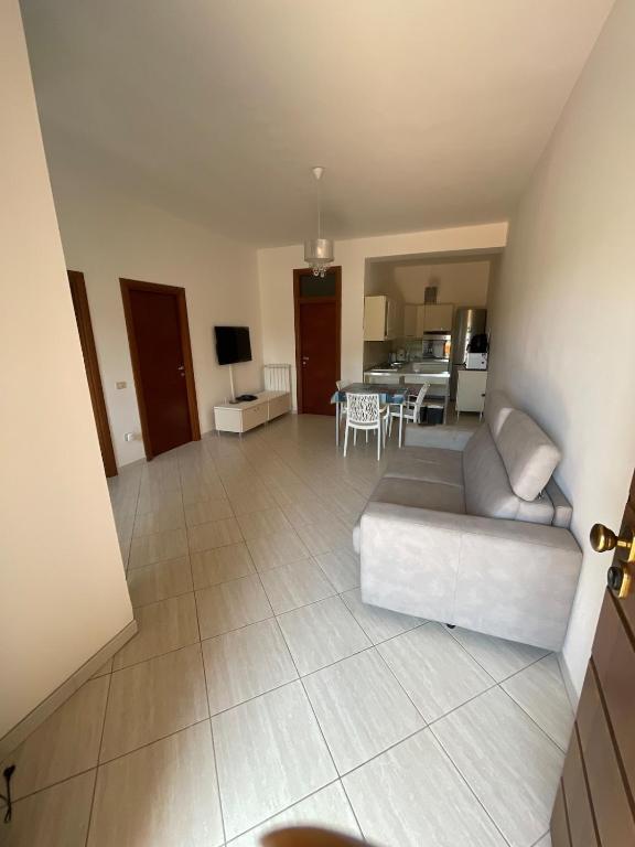 a large living room with a couch and a kitchen at Villa Agavi in Formia