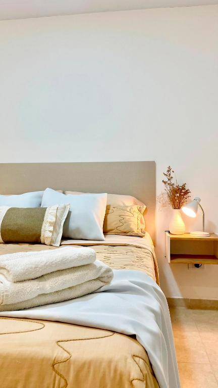 a bedroom with a bed with towels on it at Dalia Pampa in RSA