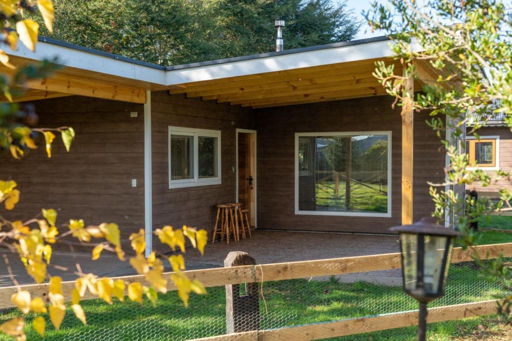 a small house with a porch and a patio at Cabañas descanso verde in Puerto Octay