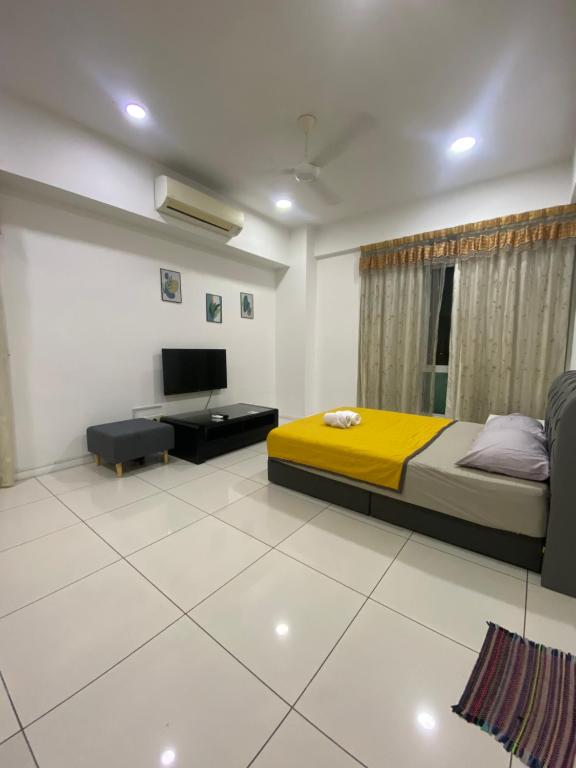a bedroom with a bed and a tv in it at Sutera Avenue near Gleaneagle KK King Bed in Kota Kinabalu