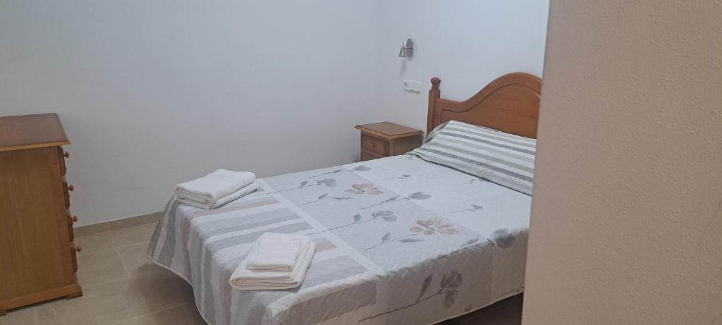 a bedroom with a bed with two towels on it at Apartamento calle Senado in Garrucha