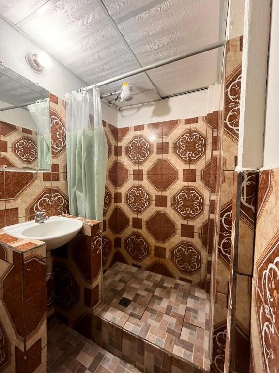 a bathroom with a sink and a shower at Hotel Casa don Angel in Las Victorias