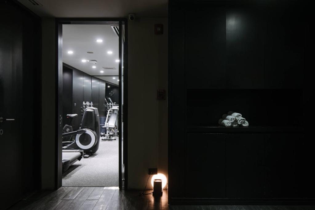 A softly lit corridor opens onto the hotel's exercise room.