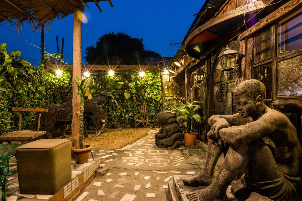 een standbeeld van een man die buiten een gebouw zit bij Bogobiri House in Lagos