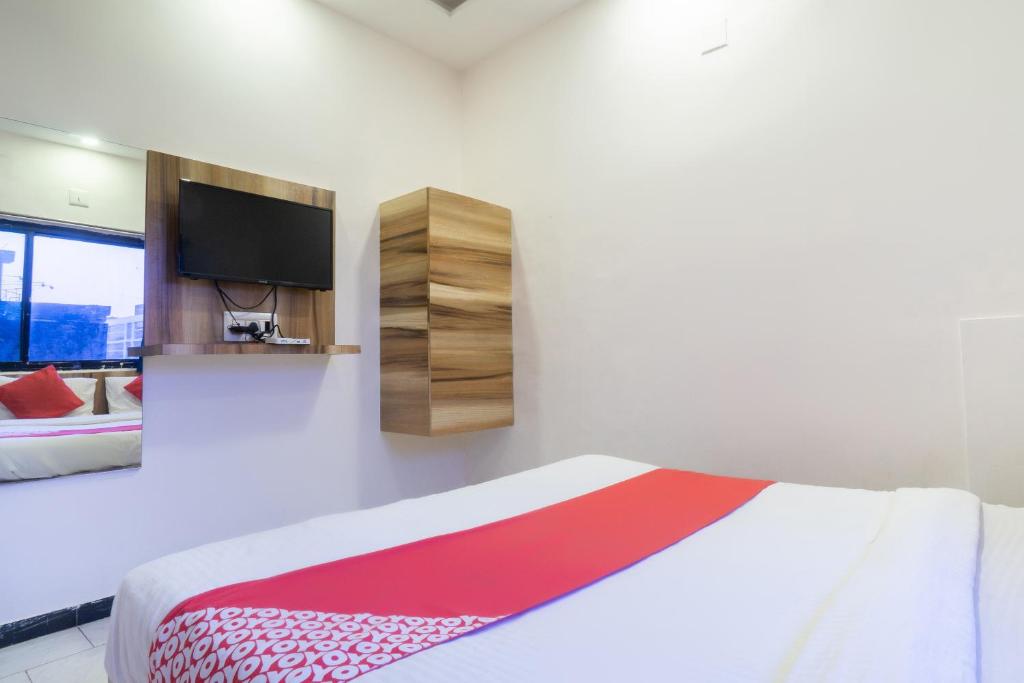 Postel nebo postele na pokoji v ubytování Hotel O Swell