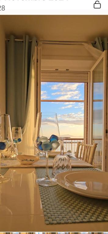 a dining room with a table with a view of the ocean at Blue Eyes L'INCANTESIMO SUL MARE in Gaeta