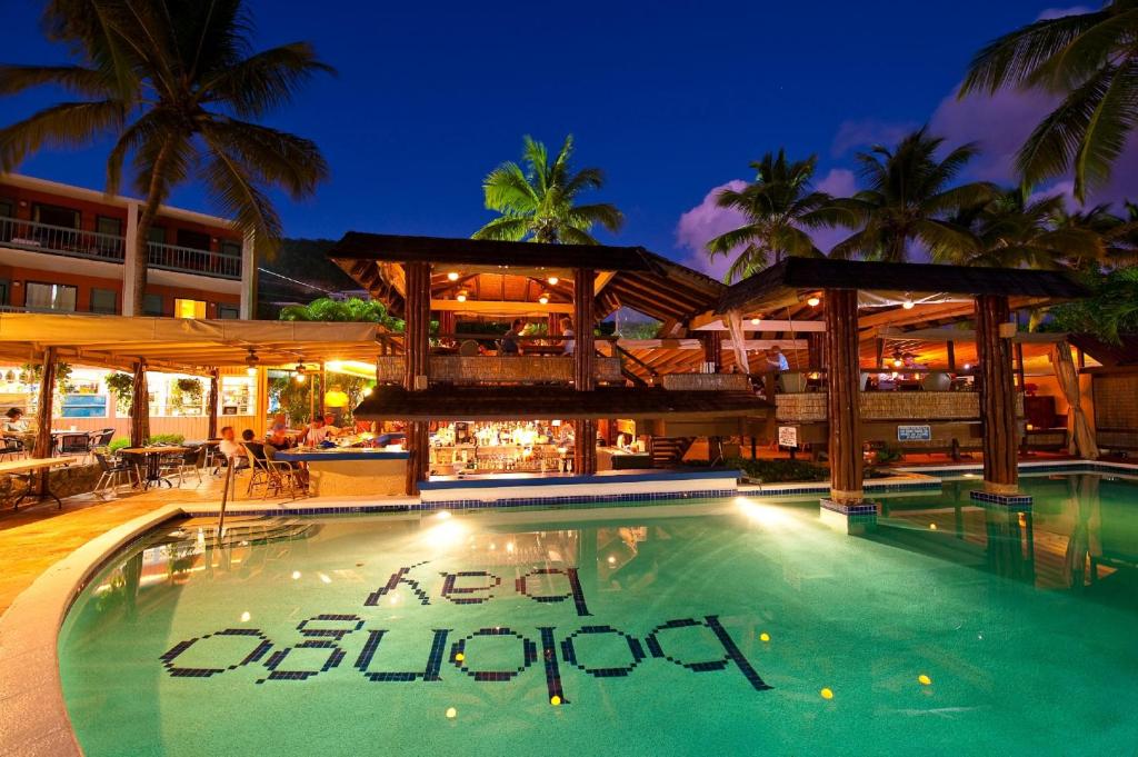 a swimming pool at a resort at night at Bolongo Bay Beach Resort All Inclusive in Bolongo