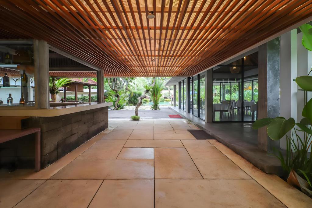 an open hallway of a building with a wooden ceiling at Belvilla Y Resort Near Central Ubud in Ubud