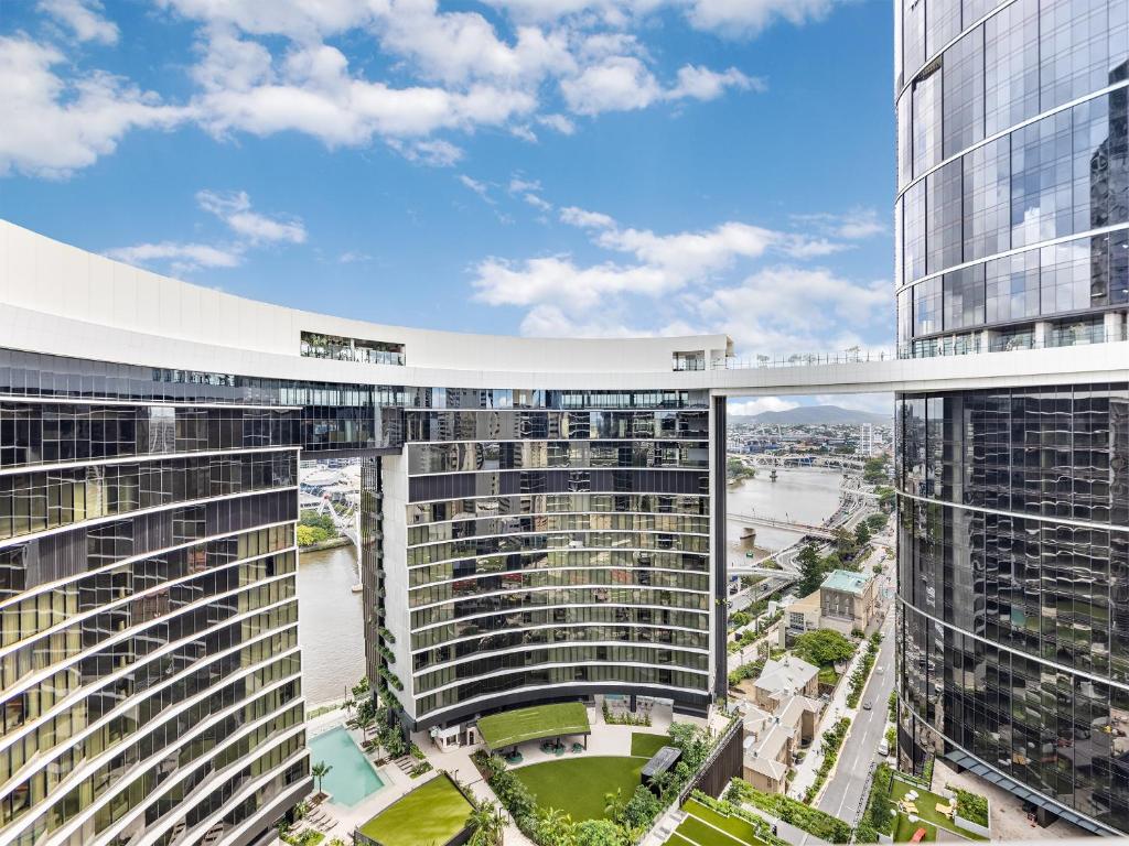 an elevated view of a city with tall buildings at Sky Living & River Views in Queens Wharf Residences in Brisbane
