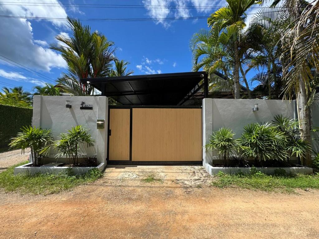 a wooden gate with plants in front of it at Silver Palm Tree Villa - 2 Bedrooms Villa in Ao Nang Beach